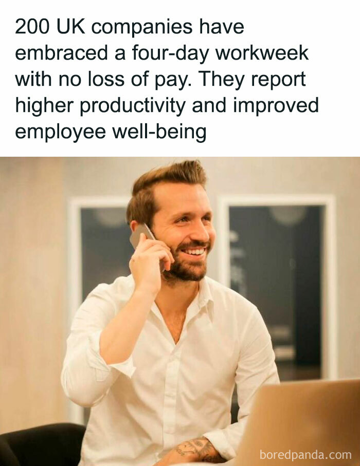 Smiling man in an office talking on the phone, illustrating positive posts about improved productivity and well-being.