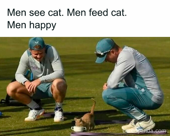 Two men in sportswear crouch on grass, smiling as a cat drinks from a bowl, a wholesome meme about happiness and cats.