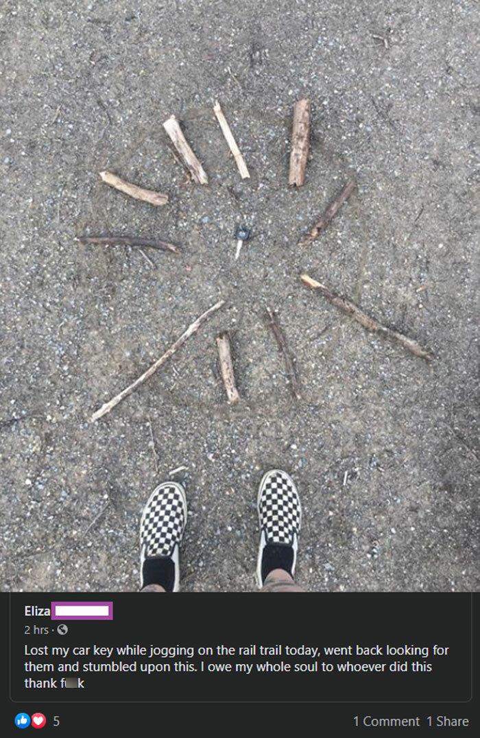 A creative arrangement of sticks on the ground with a car key in the center, capturing pure and uplifting moments.
