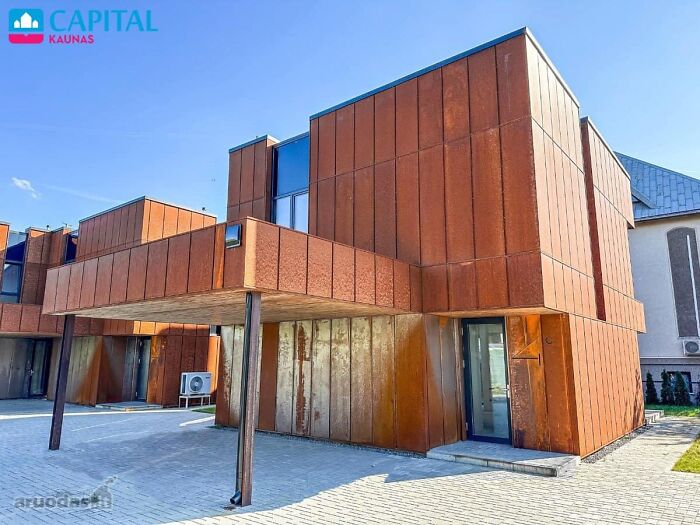 Modern rust-colored real estate property with unique architecture and a carport, one of the wildest homes for sale.