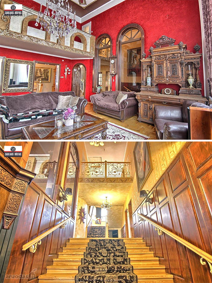 Luxurious living room and ornate staircase inside one of the wildest real estate properties for sale with vintage wood and decor.