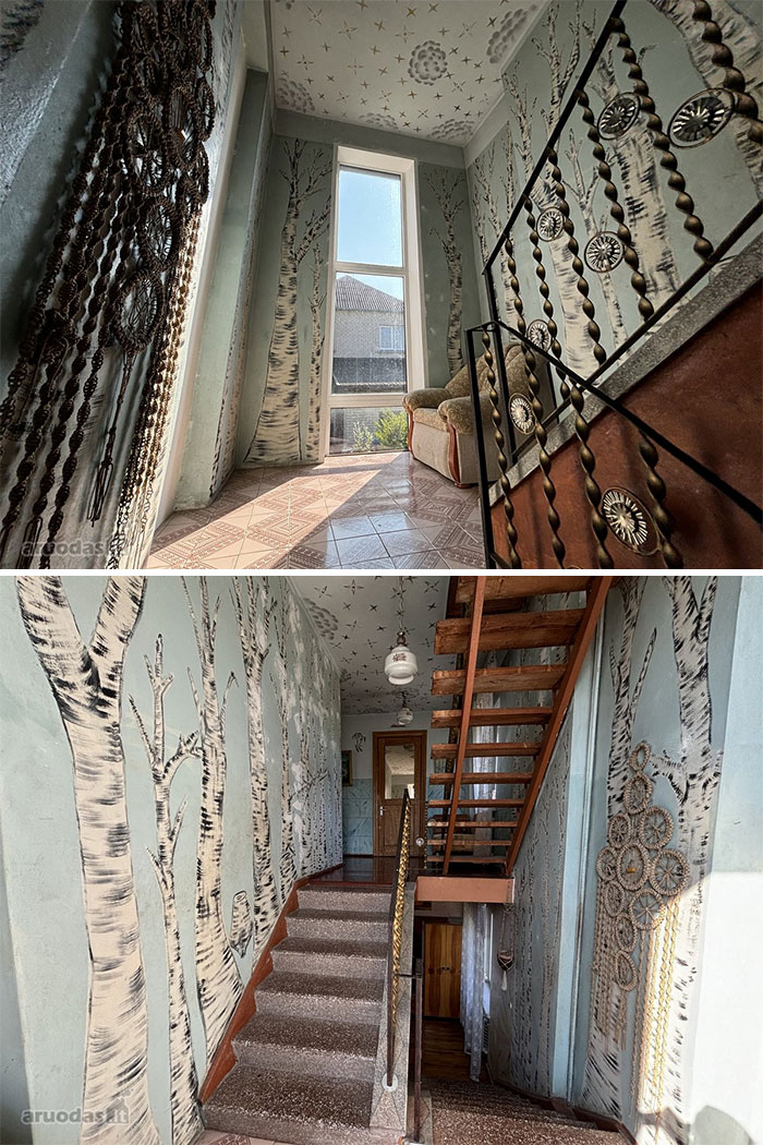 Interior of a wild real estate property featuring birch tree murals and unique stair railings in a bright sunlit space.
