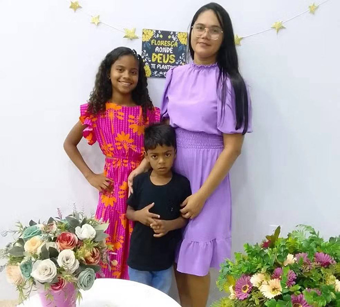 A family with flowers, including a young boy who fell victim to a tragic event involving Easter treats. A family with flowers, including a young boy who fell victim to a tragic event involving Easter treats.
