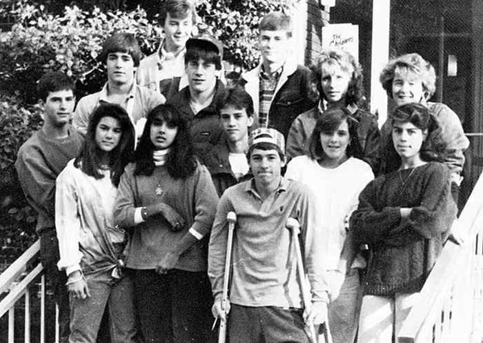 Group of university students posing together outside, some smiling, related to Jon Hamm's past.