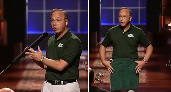 Man presenting a product on Shark Tank, demonstrating features and wearing a green shirt on set with blue lighting.