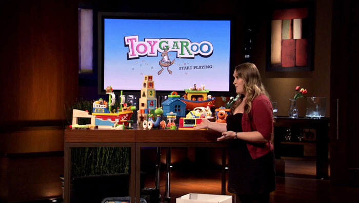 Entrepreneur presenting colorful Toygaroo products on Shark Tank stage showcasing unique items in Shark Tank products that flopped.