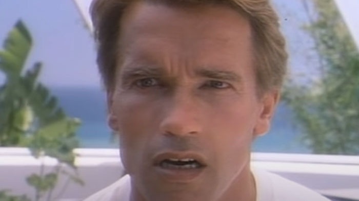 Man outdoors near plants and ocean, expressing surprise; a representation of Hollywood casting mistakes.