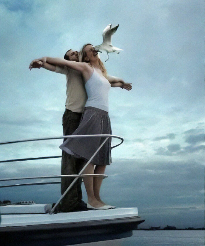 Couple striking a Titanic pose on a boat with a seagull flying perfectly aligned in this weird pics or it didn’t happen moment.
