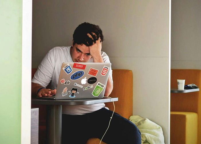 Man frustrated at laptop, representing a horrible stepmom left furious and blocked after woman gives her what she deserves.