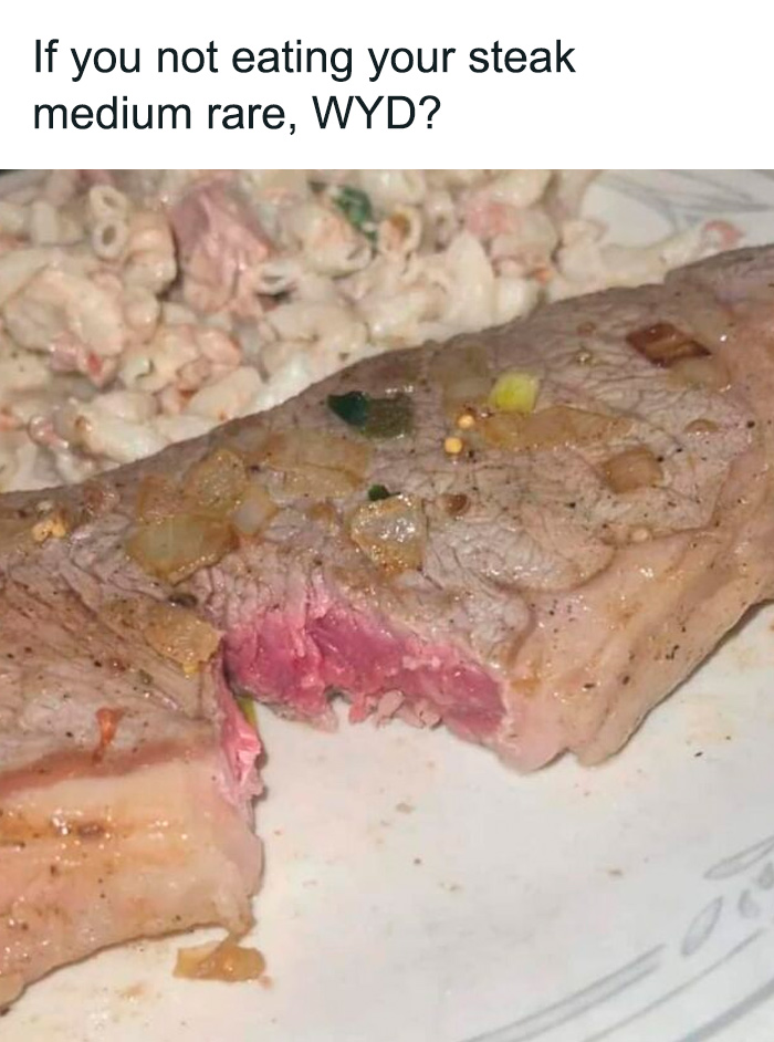 Partially cooked steak with pink center served with creamy pasta salad, an example of cursed food pics.