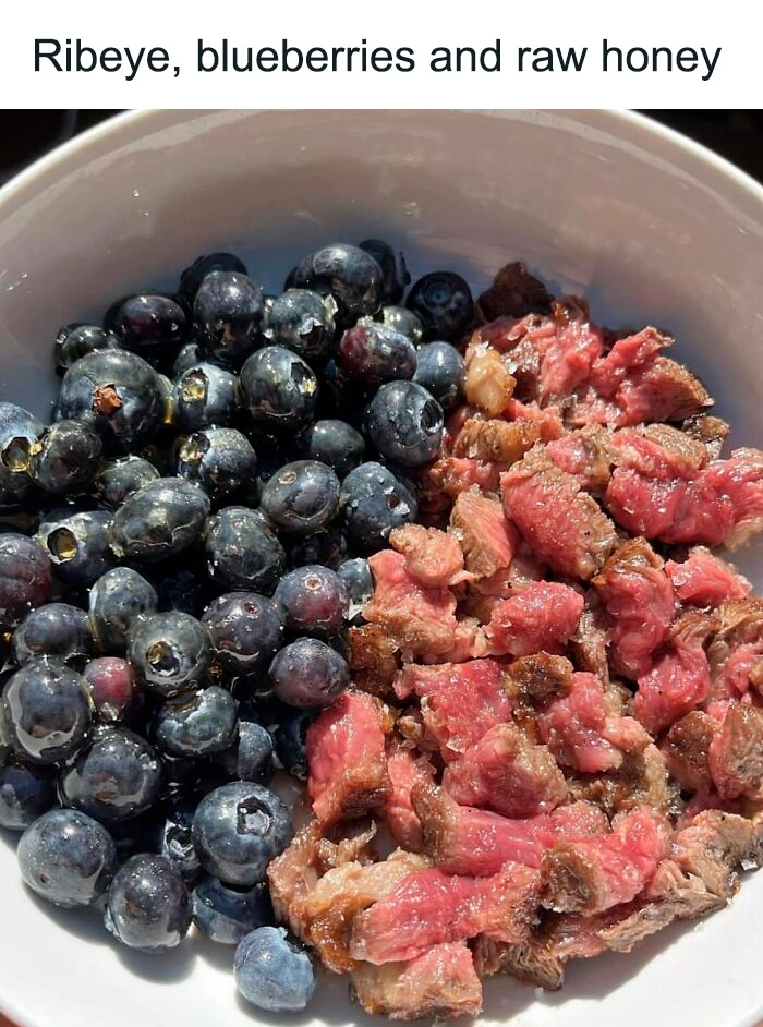 Bowl of raw ribeye and fresh blueberries, an example of cursed food pics that might need a trigger warning.