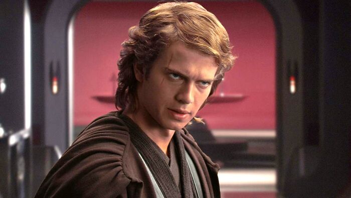Anakin Skywalker from Star Wars in a dark robe, appearing intense, set in a futuristic sci-fi interior.