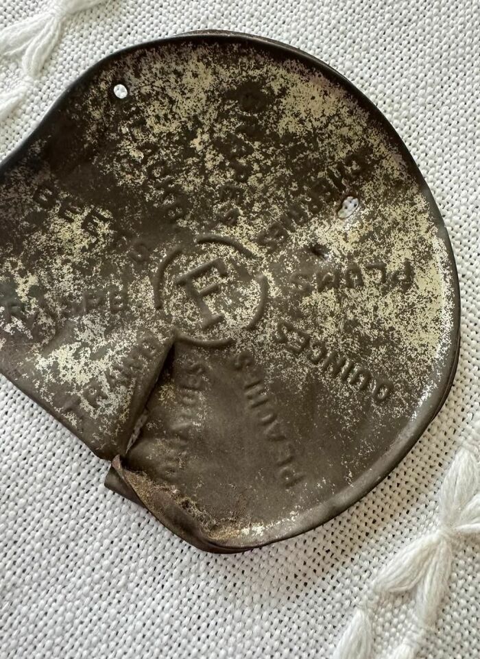 Old rusty metal object with faded lettering, one of the strange things found in homes with hidden pasts.