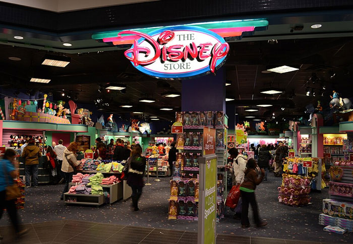 Inside a busy retail store showing shoppers and employees, highlighting disturbing workplace secrets from former employees.