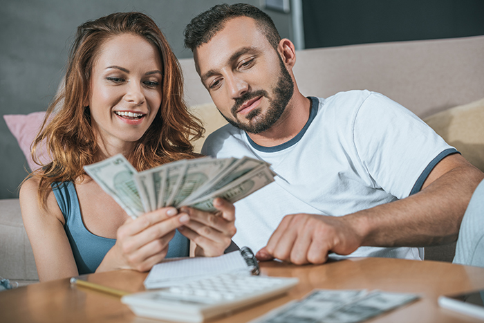 Husband and wife counting cash together, managing wealth carefully to protect it from dysfunctional families. Husband and wife counting cash together, managing wealth carefully to protect it from dysfunctional families.