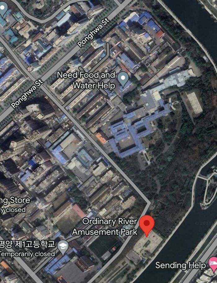 Aerial view showing an unusual message on Google Earth near Ordinary River Amusement Park and nearby streets.