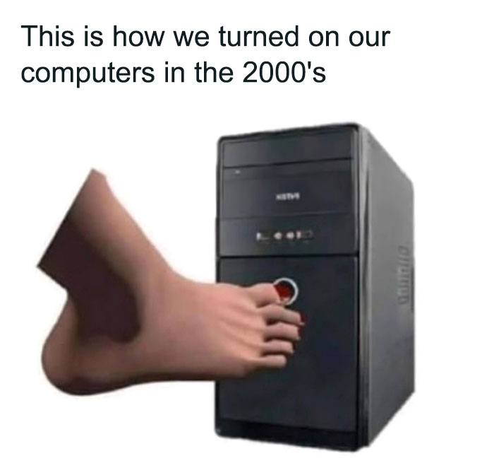 Foot pressing the power button on a black computer tower illustrating nostalgic 2000s memories and technology use.