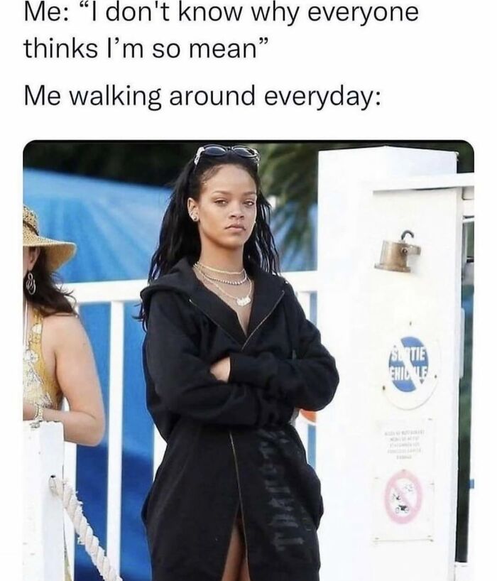 Woman in black hoodie with crossed arms, expressing a mean attitude, reflecting cute and wholesome girlies posts.