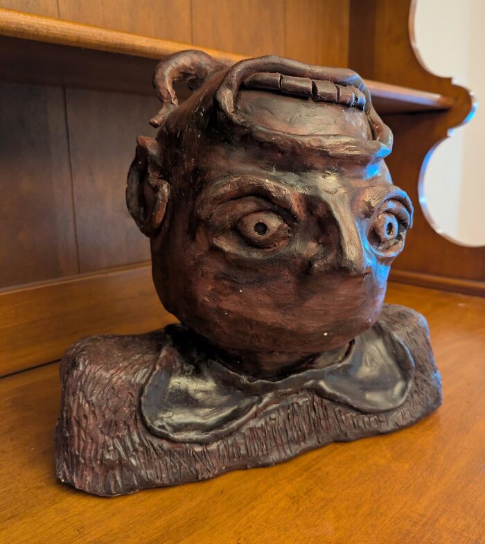 Ceramic bust with exaggerated eyes and features, a weird and wonderful thrifted find resembling museum art.