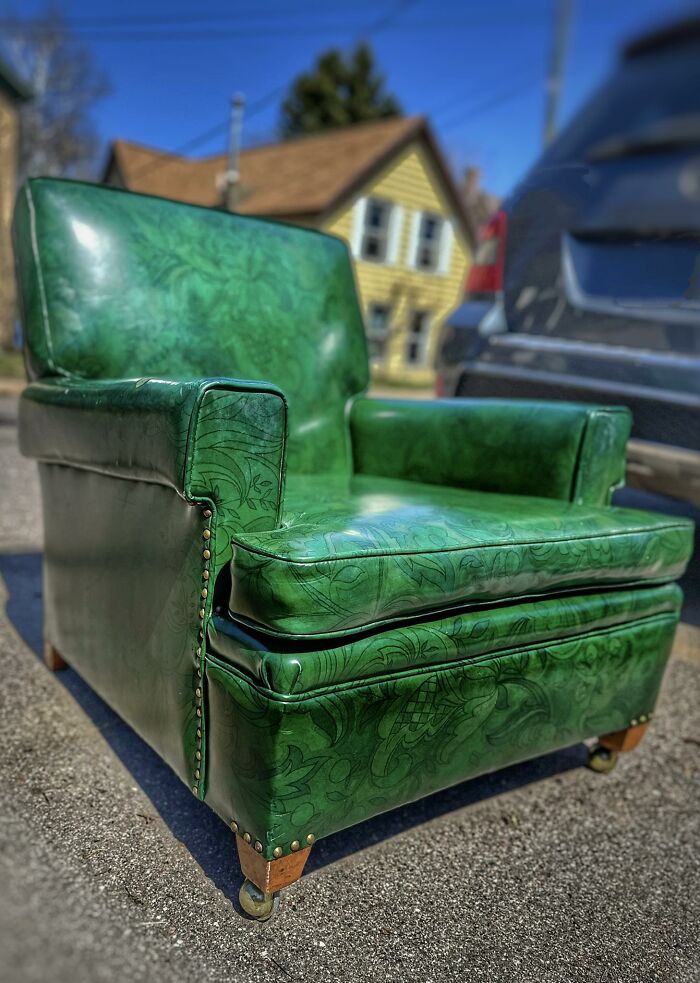Green vintage armchair with embossed patterns, a unique thrifted find featured for its weird and wonderful charm.