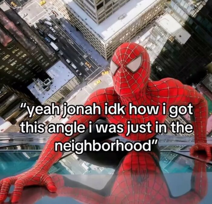 Spider-Man on a skyscraper taking a chaotic meme selfie with humorous text for when life gets boring.