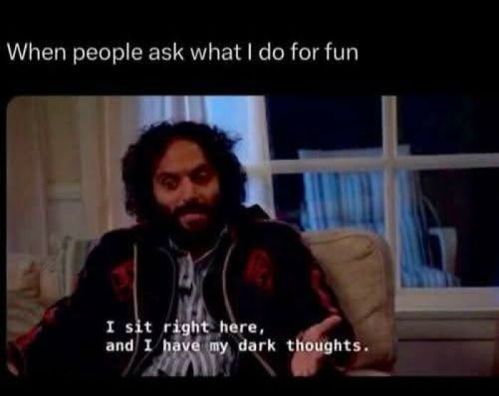 Man sitting on a couch expressing dark thoughts with a humorous tone in a funny pic for mental breakdown moments.