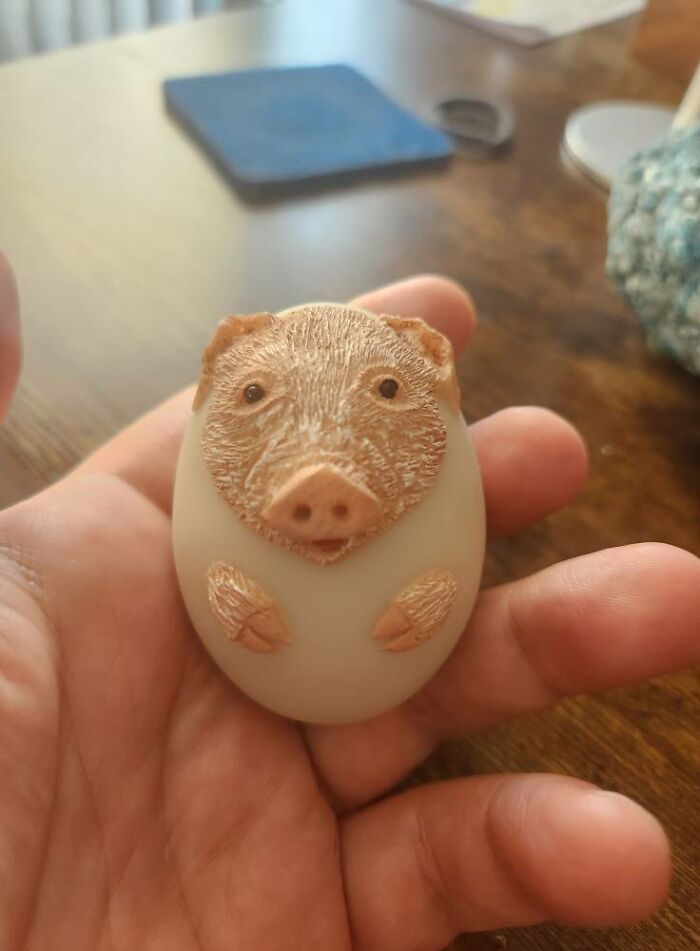 Small pig figurine sculpted on an egg-shaped object, one of the weird and wonderful thrifted finds.