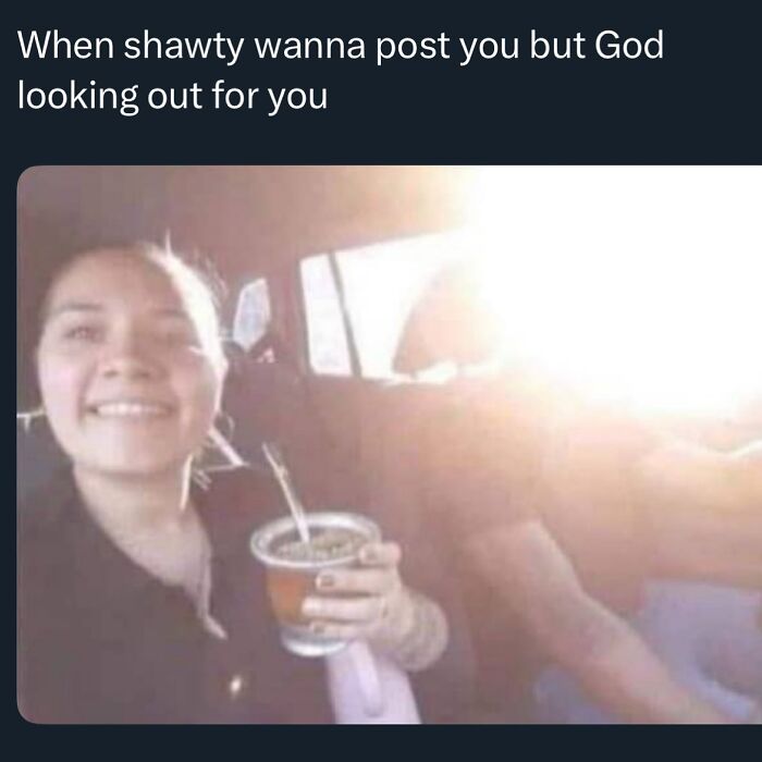 Young woman smiling in a car holding a drink with sunlight shining, a funny random meme to make you giggle like a schoolgirl.