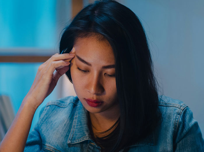 Woman in denim jacket looking stressed and contemplative, illustrating husband and wife conflict online discussion. Woman in denim jacket looking stressed and contemplative, illustrating husband and wife conflict online discussion.