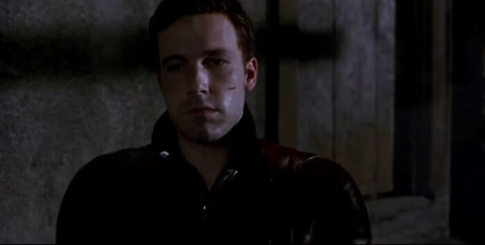 Actor in a dark scene portraying a troubled character, representing miscast actors who impacted movies negatively.