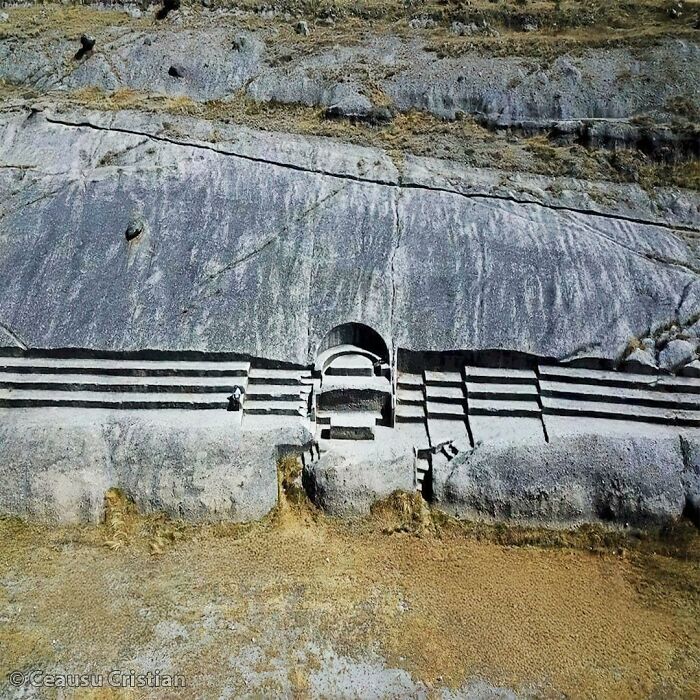 Ancient rock-carved structure with steps and arch, showcasing interesting posts about our ancient history and archaeology.