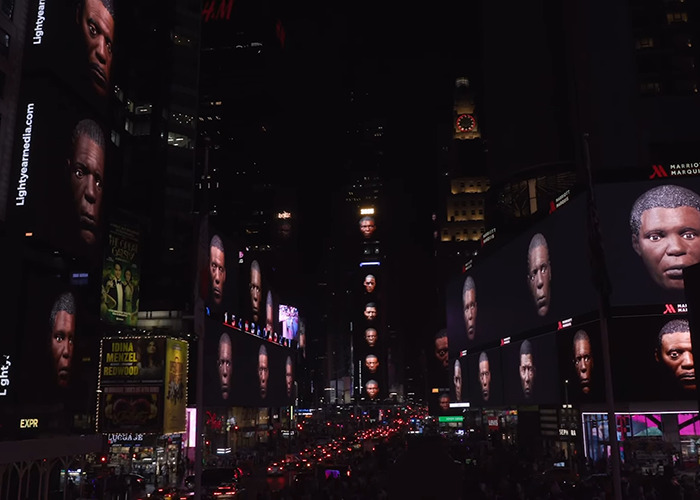Times Square digital billboards displaying multiple faces leading to debate over statue of Black woman in NYC.