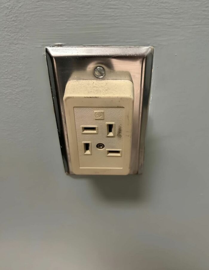 Old electrical outlet with unusual design found in a home with hidden and forgotten strange past.