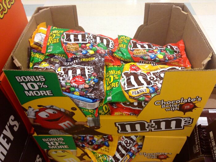 Boxes of peanut M&M’s candy on display in a store, highlighting popular restaurant food snacks and price changes.