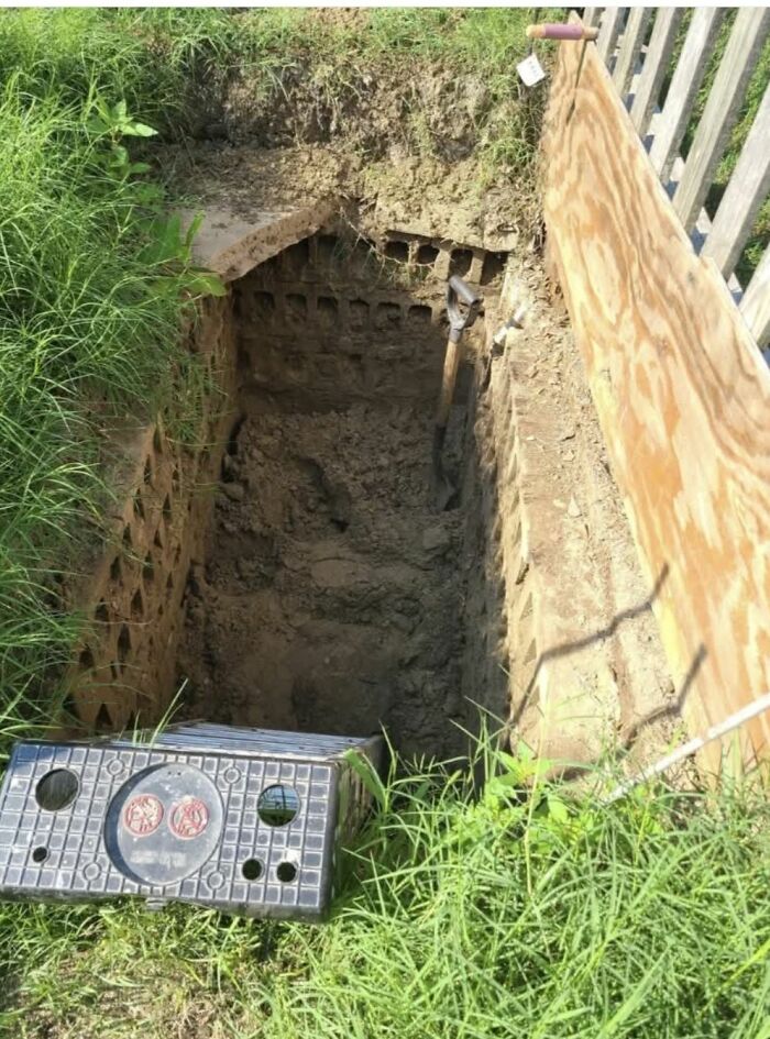 Deep hole dug in yard with bricks lining the walls, revealing strange things found in homes with hidden pasts.