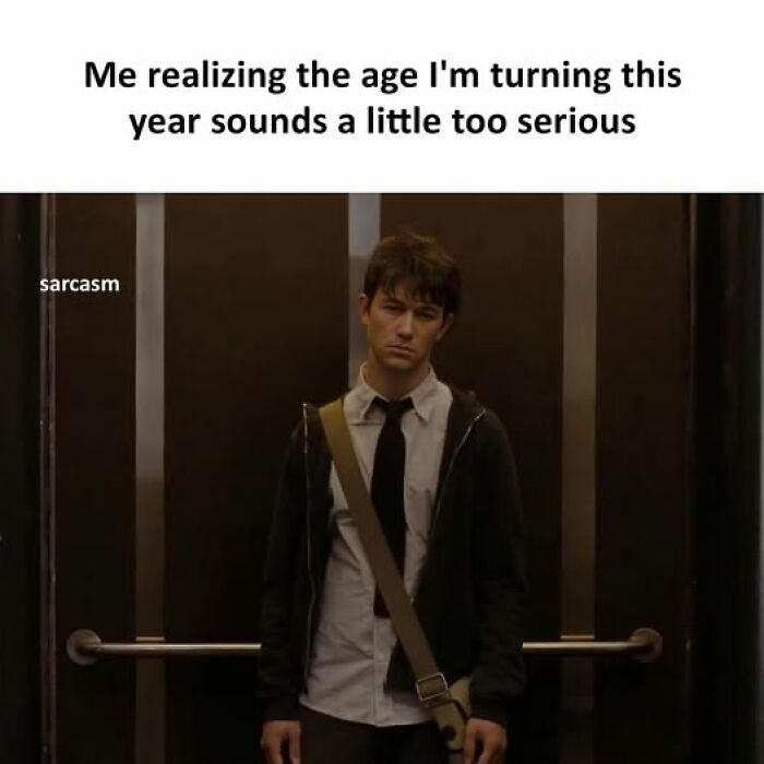 Young man looking serious in an elevator, reflecting the tone of hilarious memes about growing older from a popular Facebook page.