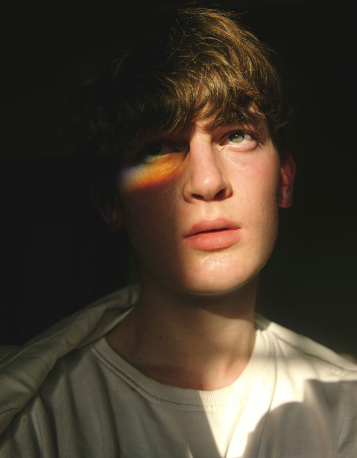 Young man with thoughtful expression and shadowed face, symbolizing reflection on friendship of 10 plus years ended.