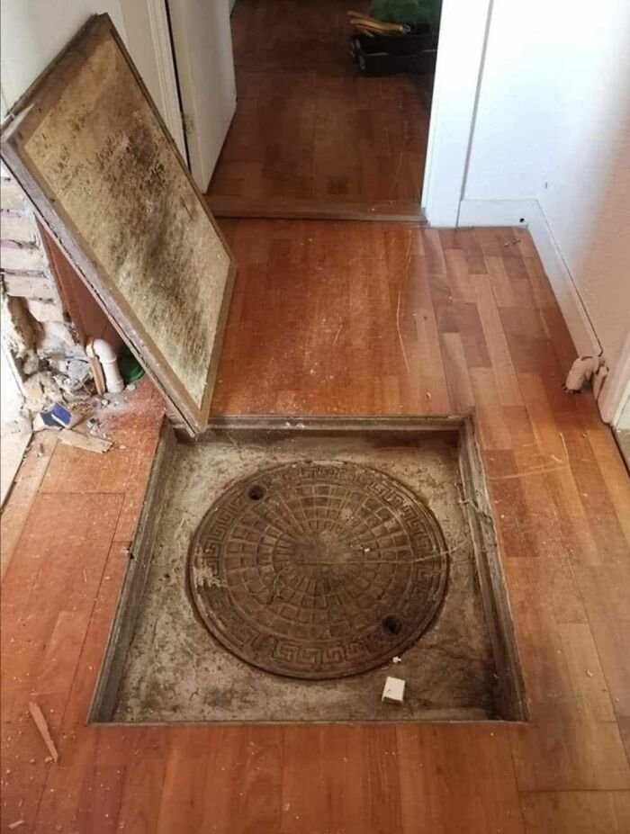 Hidden manhole cover found inside a home with a forgotten past, revealing strange and unusual items beneath the floor.
