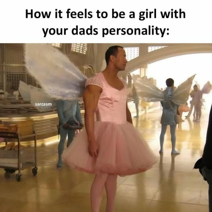 Man dressed in a pink tutu and fairy wings illustrating hilarious memes about dads' personalities in a comedic setting