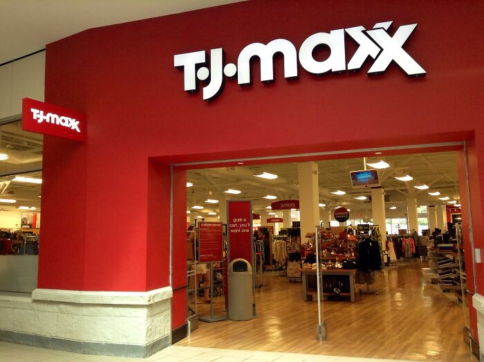 T.J. Maxx store entrance with red walls and visible interior showcasing company secrets shared by former employees.