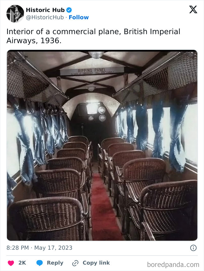 Interior of a 1939 commercial airplane with wicker seats and blue curtains, capturing monumental life moments frozen in time.