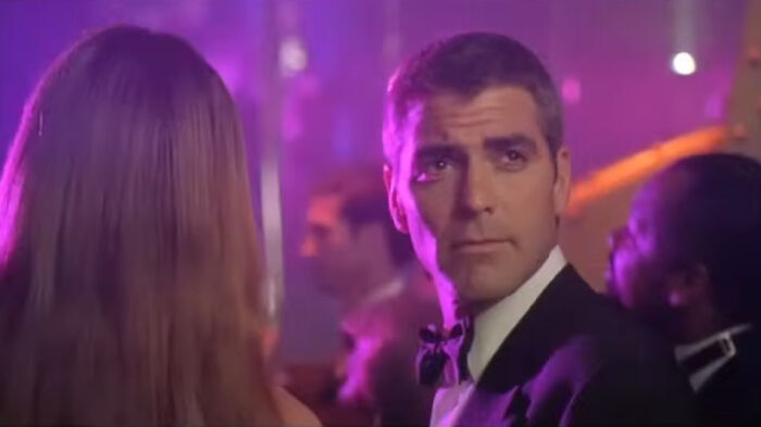 Actor George Clooney in a tuxedo at a party scene representing miscast actors in movies.