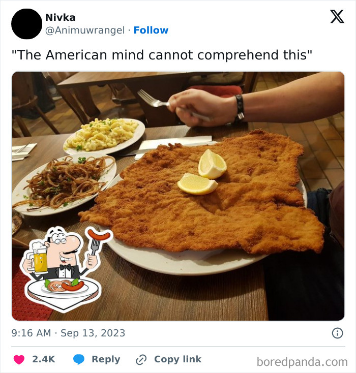 Large breaded schnitzel with lemon wedges on a plate, surrounded by sides, confusing American diners with its size.