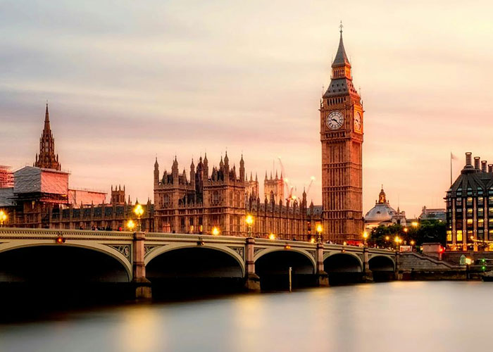 View of London’s Big Ben and Houses of Parliament at sunset representing living in home countries perspectives.