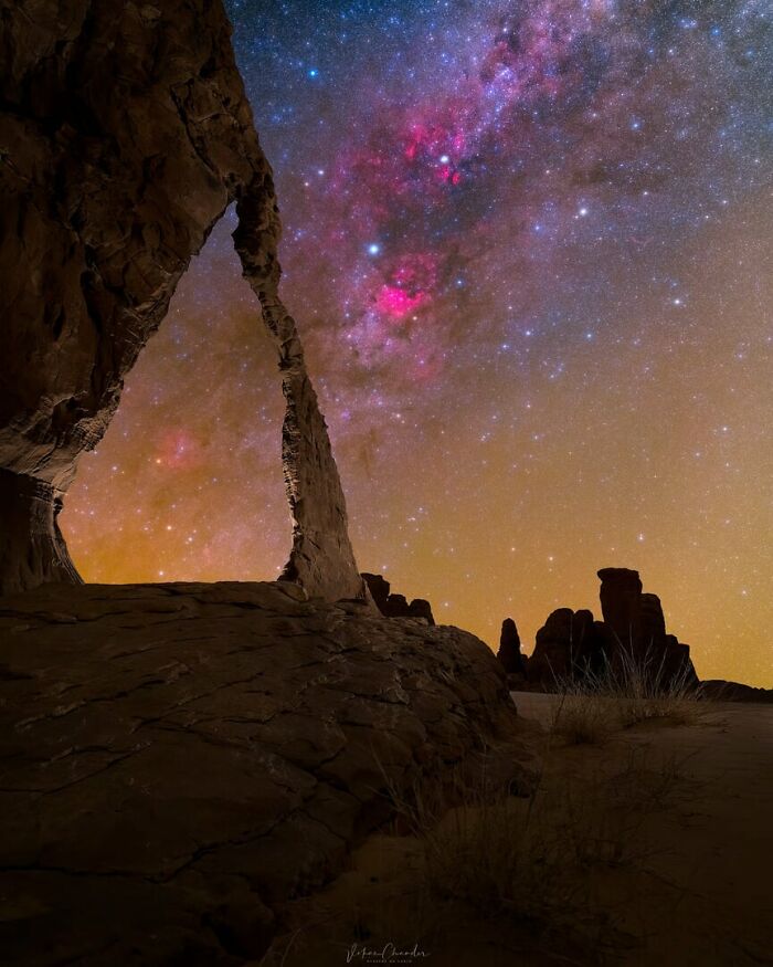 Natural rock arch under a vibrant Milky Way night sky showcasing stunning beauty of the Milky Way stars.