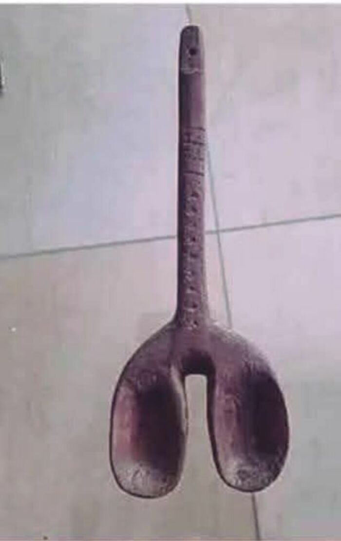 Old strange wooden tool with carved details, an unusual item found in homes with hidden or haunted pasts.