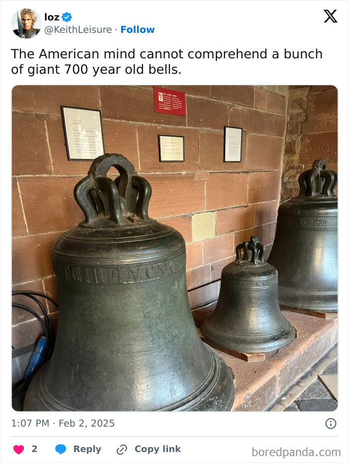 Three large ancient bronze bells displayed indoors against a brick wall, baffling the American mind.