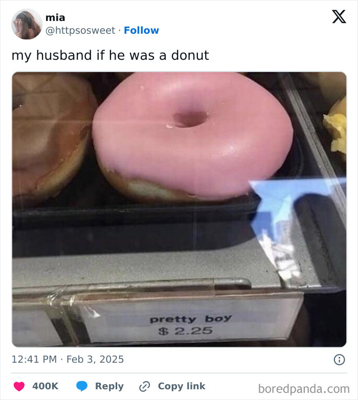 Pink-frosted donut labeled pretty boy displayed in a bakery case, a mocking posts jokes memes visual humor.