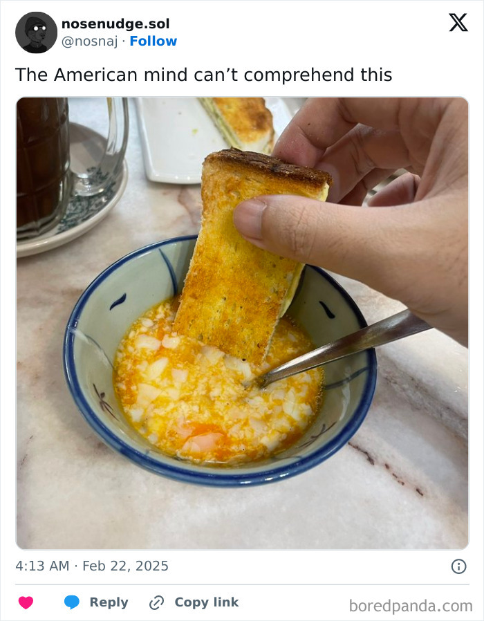 Hand dipping toasted bread into a bowl of mixed eggs, illustrating a photo that confuses the American mind.