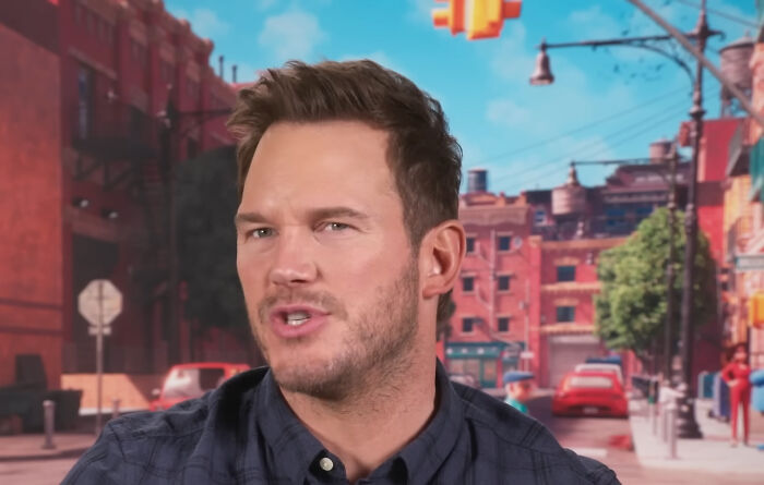 Actor Chris Pratt speaking in an outdoor animated city setting, related to miscast actors in movies.